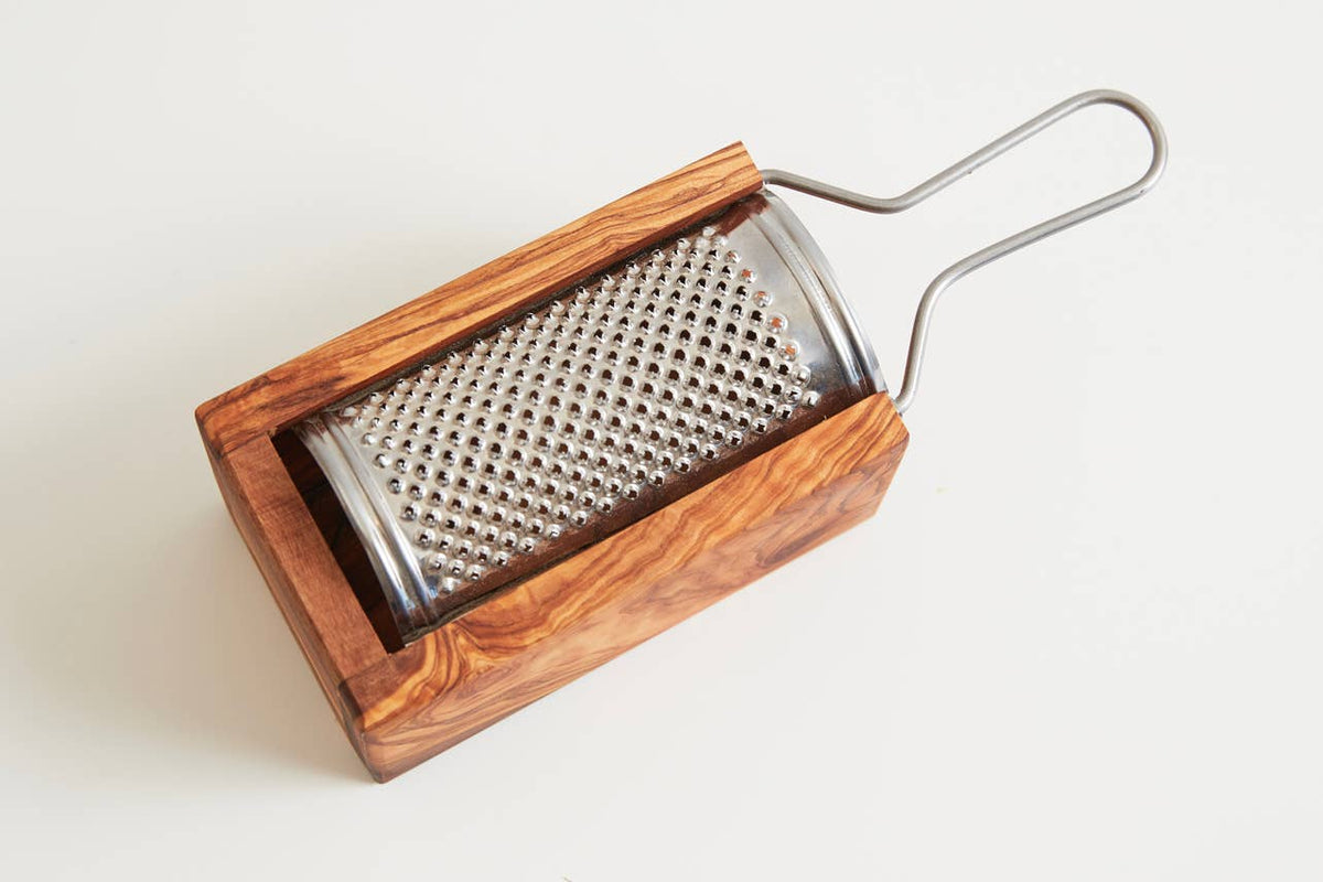 Italian olivewood box cheese grater on a white background showing the wire handle and grained olivewood box
