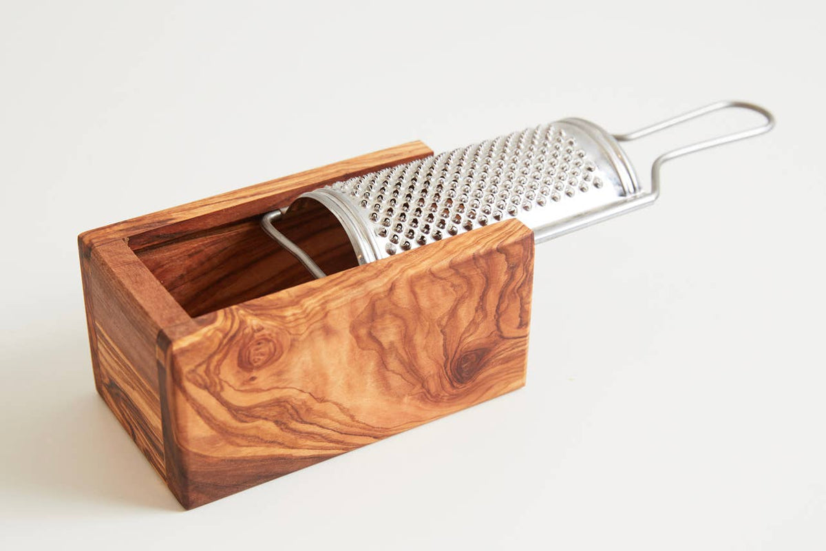 Empty Umbrian olivewood grater box showing the open interior that catches the grated cheese, with the stainless plate lifted out