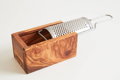 Empty Umbrian olivewood grater box showing the open interior that catches the grated cheese, with the stainless plate lifted out