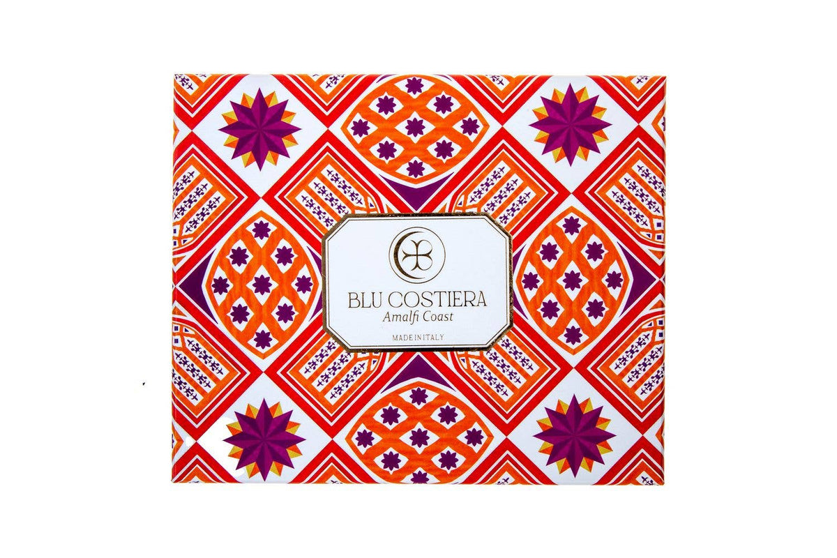 Blu Costiera Amalfi Sunset gift box closed, printed with an orange, red and magenta geometric Amalfi tile pattern with purple starbursts