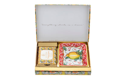 Open Positano Sunray gift box with the lid printed 'Everything starts as a dream', holding a boxed body soap and a square hand-painted Vietri ceramic soap dish with a lemon design on a red border