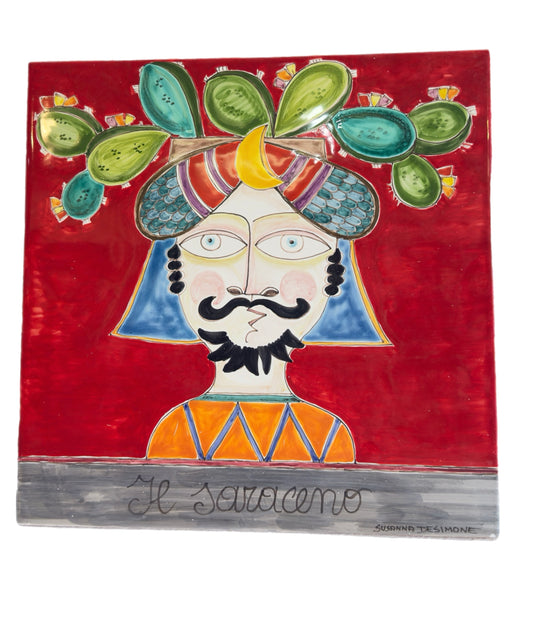 Susanna De Simone ceramic wall art titled “Il Saraceno,” depicting a Moorish King with prickly pear crown on a red background, handcrafted in Sicily.