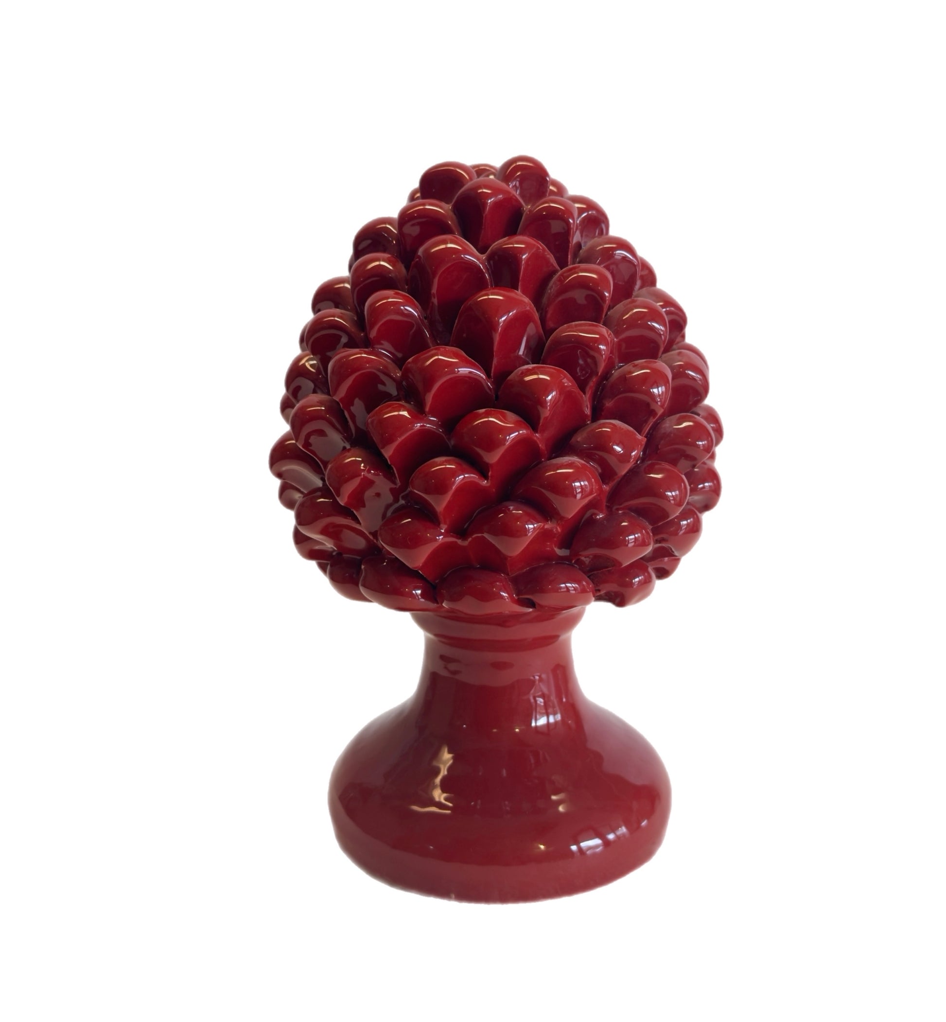 Red decorative object resembling a pineapple on a white background