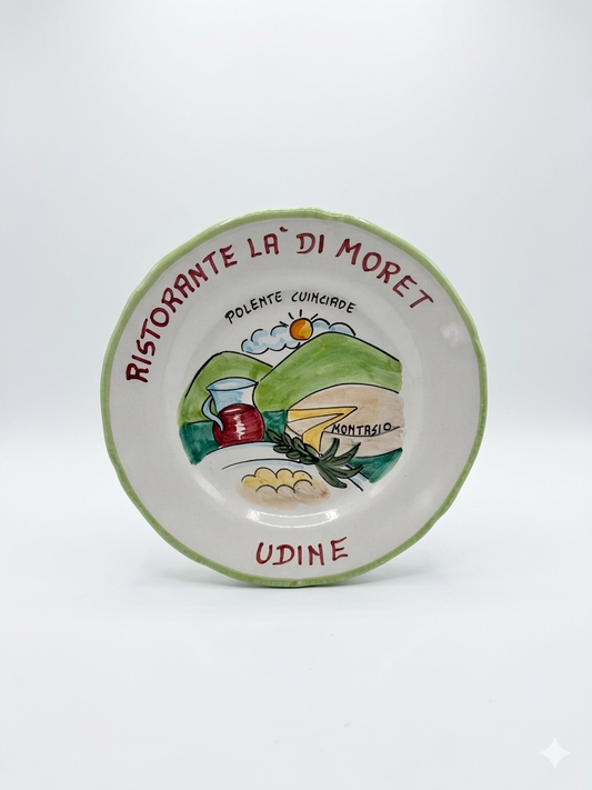 Hand-painted Italian ceramic plate from Udine with polenta, wine, and countryside scene in green border